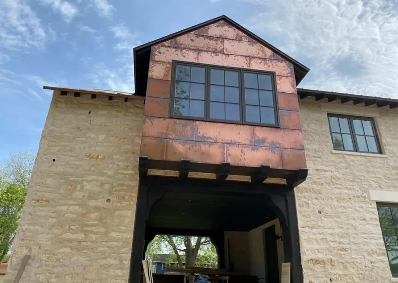 Copper metal panel facade on a stone building for Roof Repair in Evergreen Park