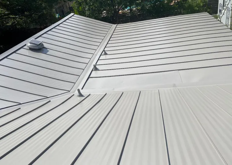 Solar attic fan installed on a metal roof for Roof Ventilation in Evergreen Park